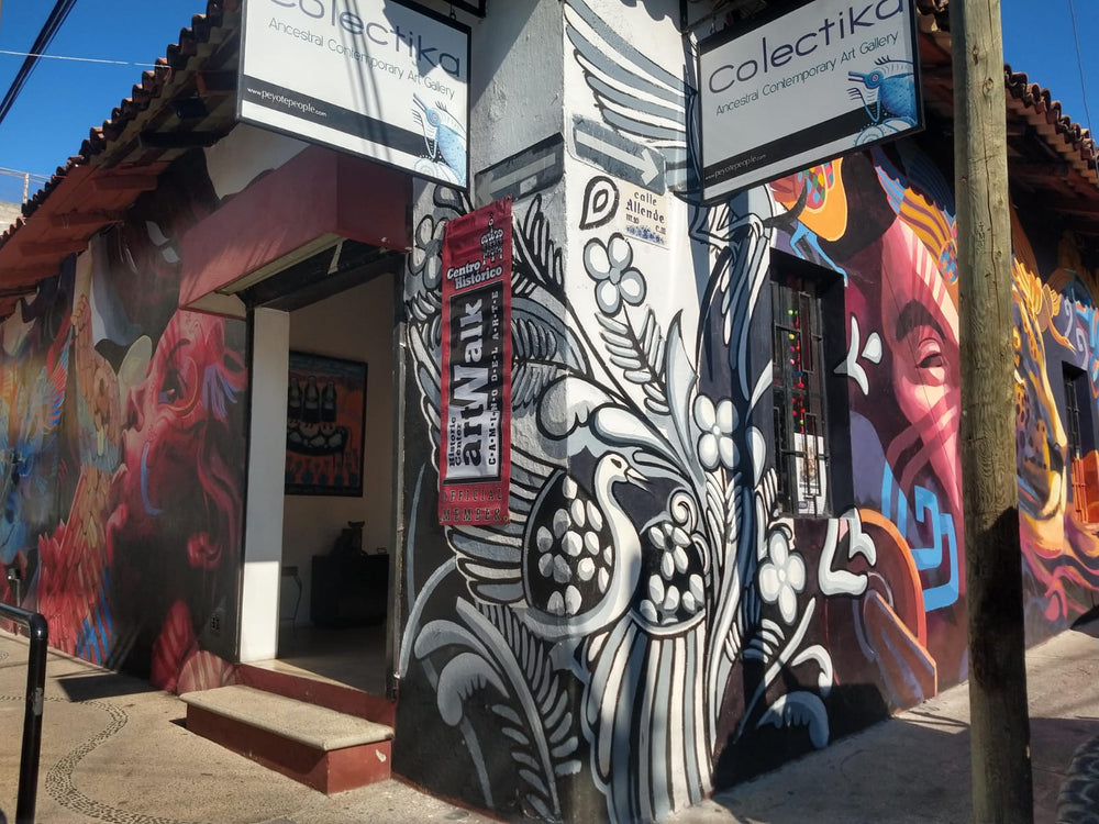 an image of the exterior of Colektika - depicted is a vivid work of surrounding the entrance.
