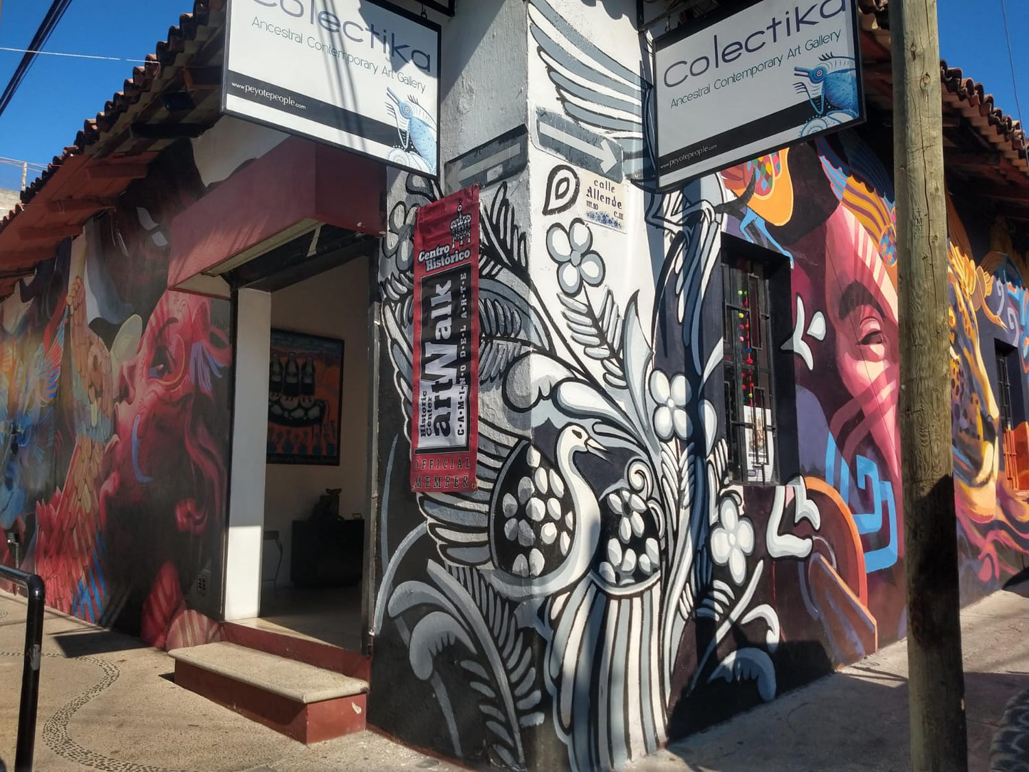 an image of the exterior of Colektika - depicted is a vivid work of surrounding the entrance.